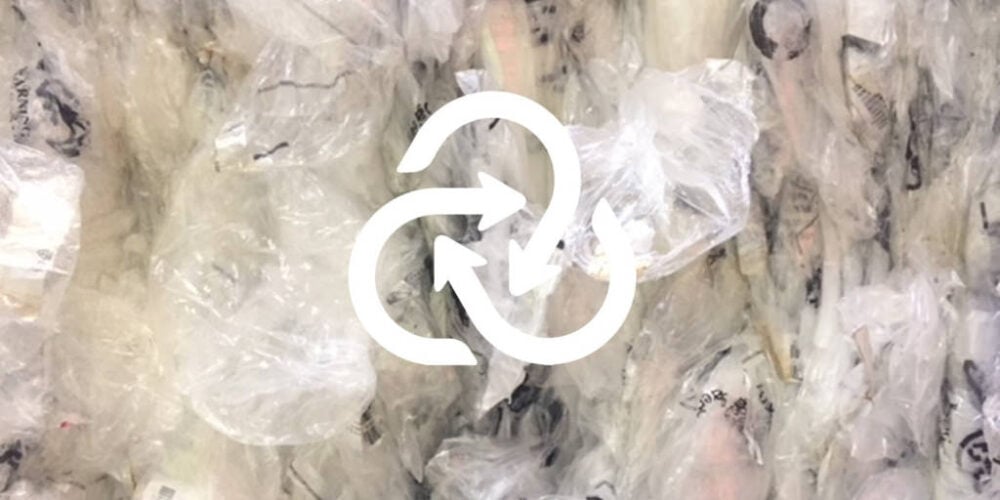 Up close clear scrap bale with closed loop recycling logo