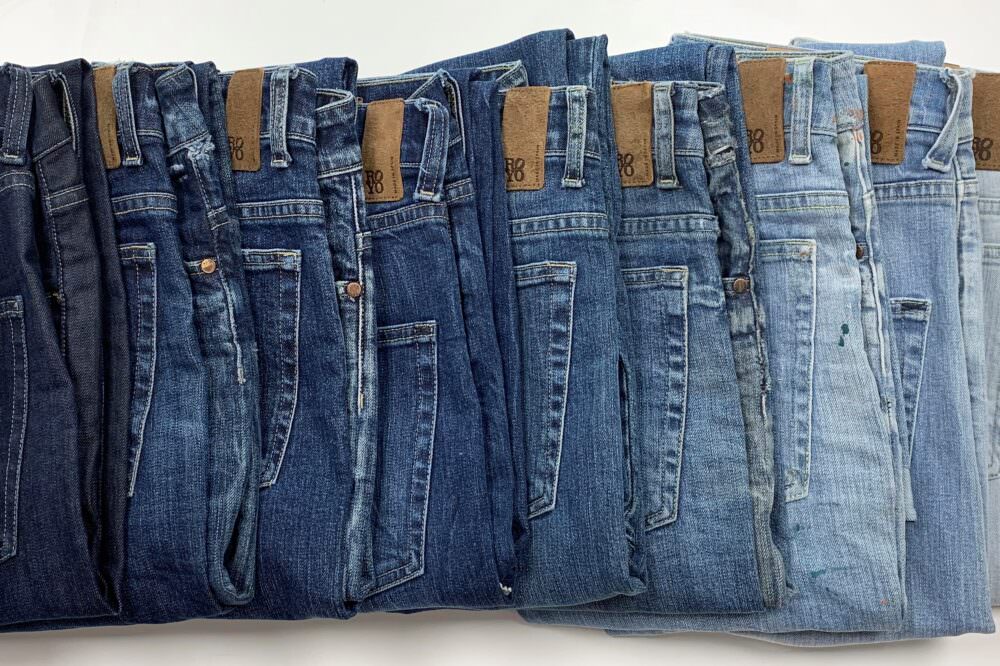 Tejidos Royo line of folded jeans in different shades of blue