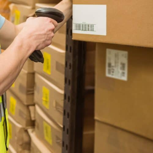 Person scanning box in a warehouse