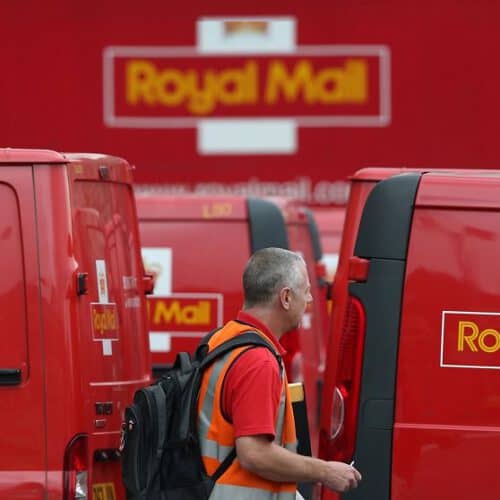 Royal mail vans and postman