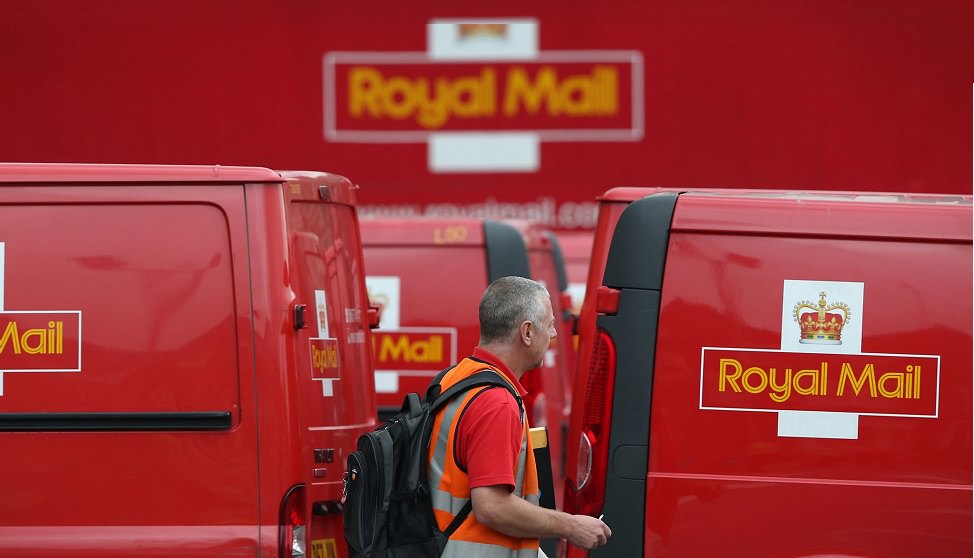 Royal mail vans and postman